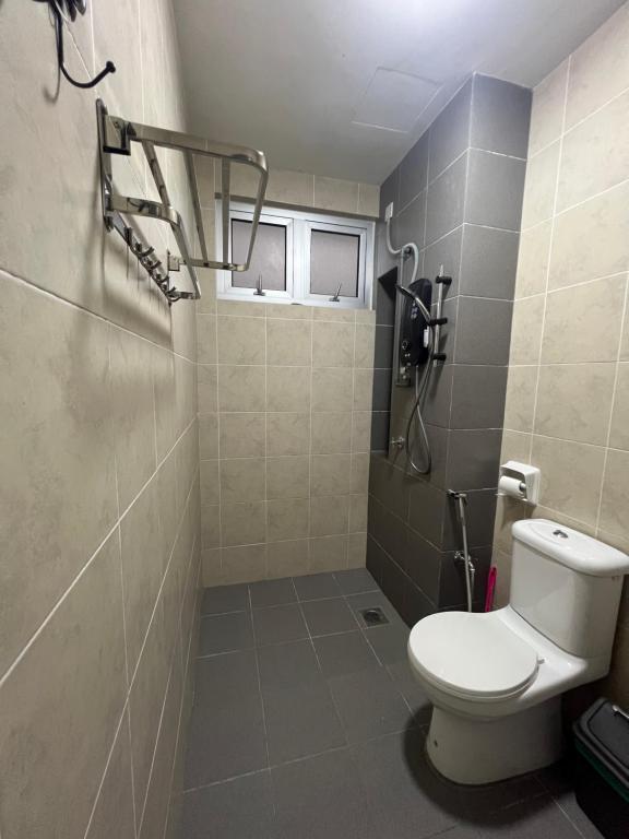 a bathroom with a toilet and a shower at Al Mansor Islamic Guestroom in Seremban