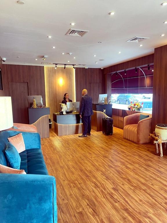 a person standing at a counter in a hotel room at AG Hotel in Abu Dhabi