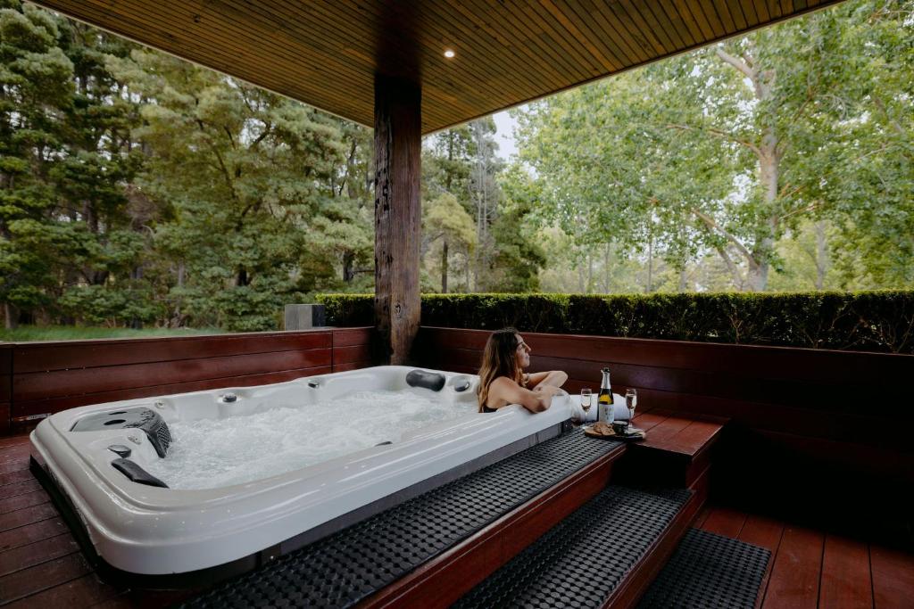 a woman sitting in a bath tub in a house at Losari Retreat in Margaret River Town