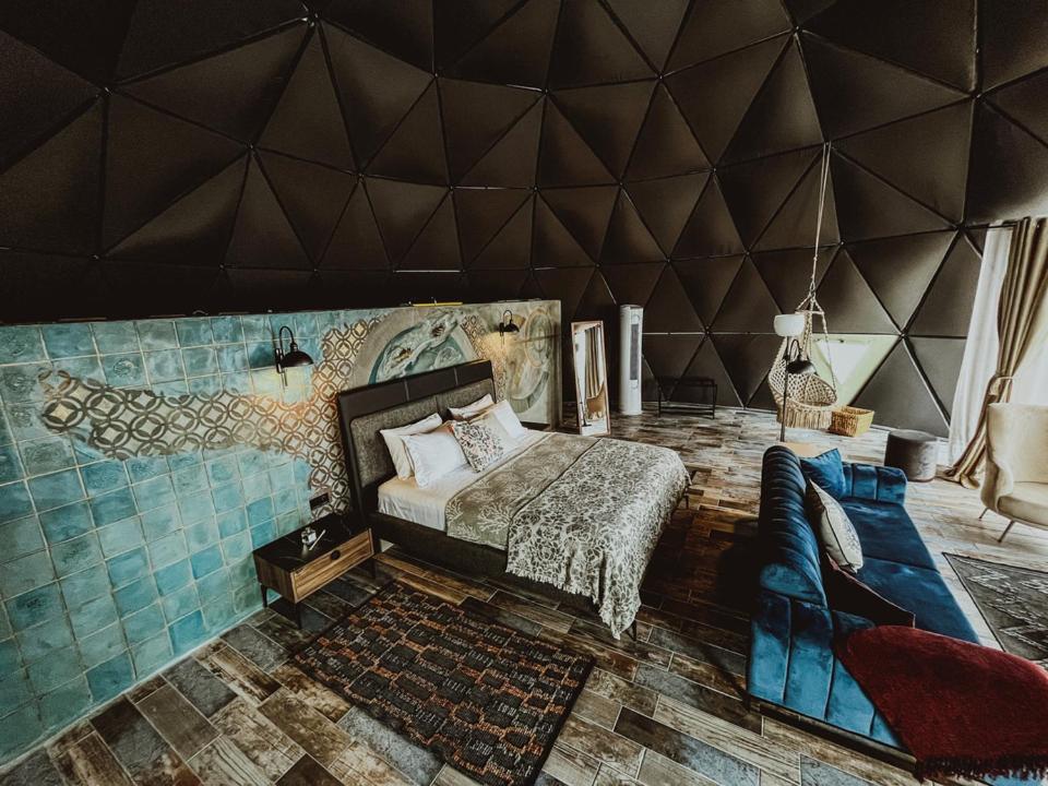 a room with a bed and a wall with arior at Alaçatı Route 35 Glamping Konaklama&Restaurant in Germiyan