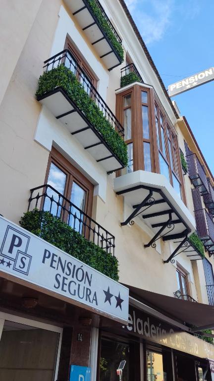 a building with a sign for a pension sephora at Pension Segura in Murcia
