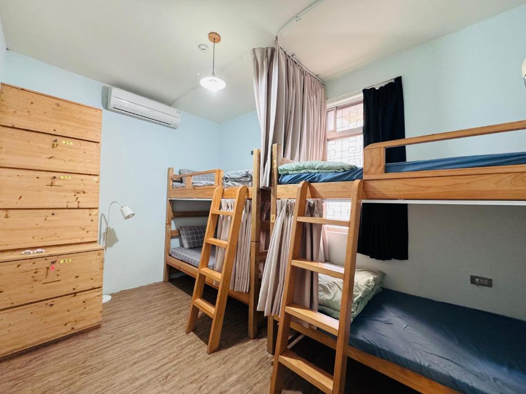 a dorm room with four bunk beds in it at MatchBox Hostel in Longjing