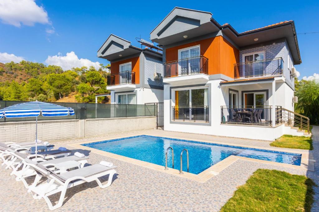 a villa with a swimming pool and a house at Villa Sasha 2 in Ortaca