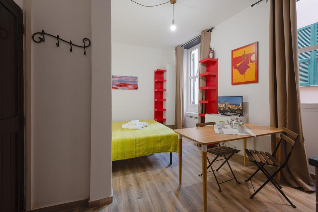 ジェノヴァにあるAppartamento Maddalena Basso - Affitti Brevi Italiaのベッド、テーブル、デスクが備わる客室です。