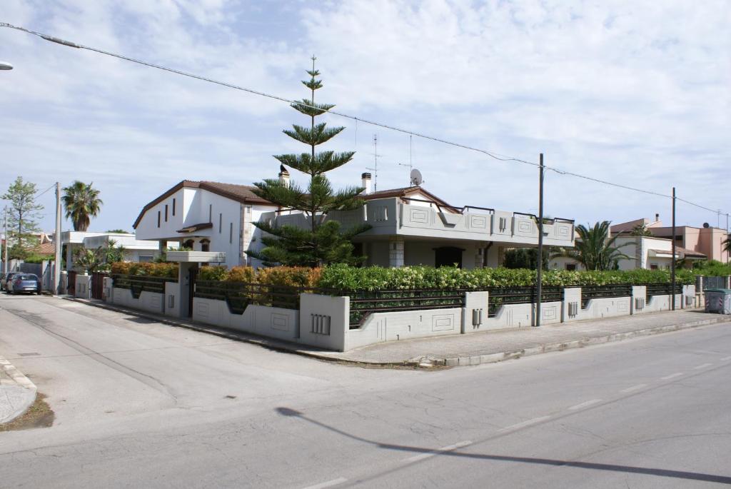 una casa con un albero di Natale sul lato di una strada di B&B Del Maresciallo a Leporano