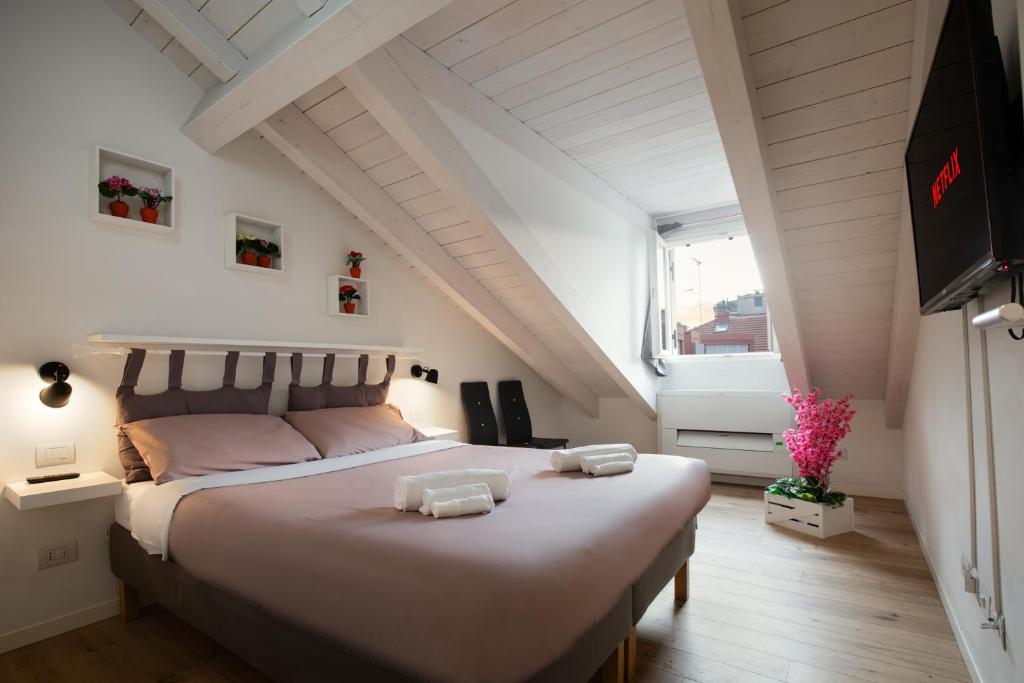 a bedroom with a large bed in a attic at Milano Duomo-Central Station wifi-Netflix-metrò in Milan