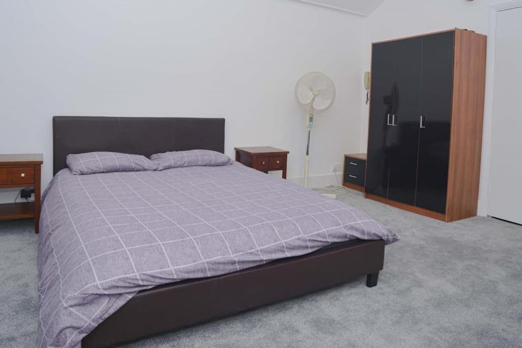 a bedroom with a bed and a dresser and a closet at SOHO Flat (Central London) in London
