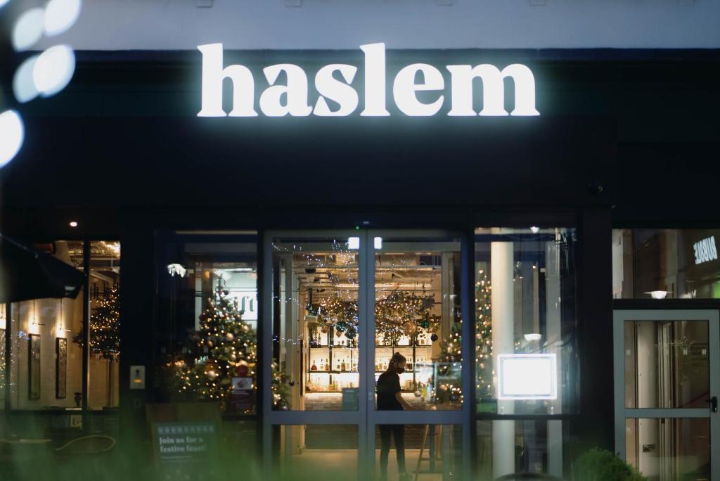 a woman walks in front of a fashion store at Haslem Hotel in Lisburn