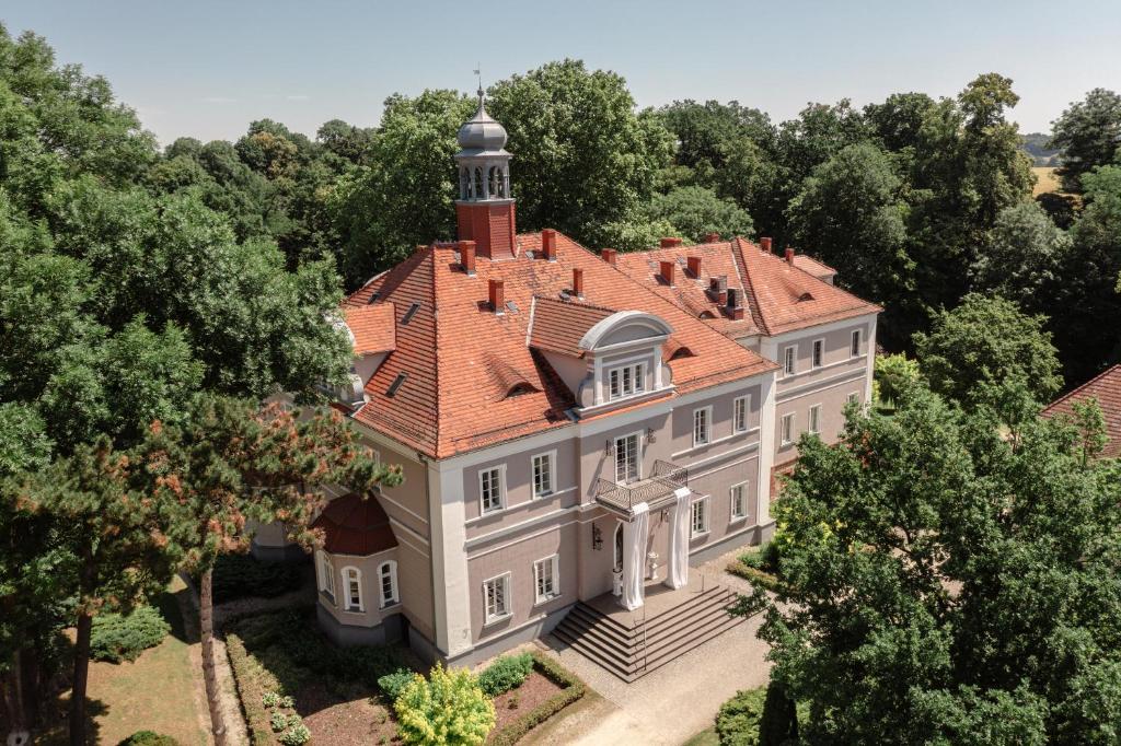 an aerial view of a large mansion with a red roof at Pałac Konary 