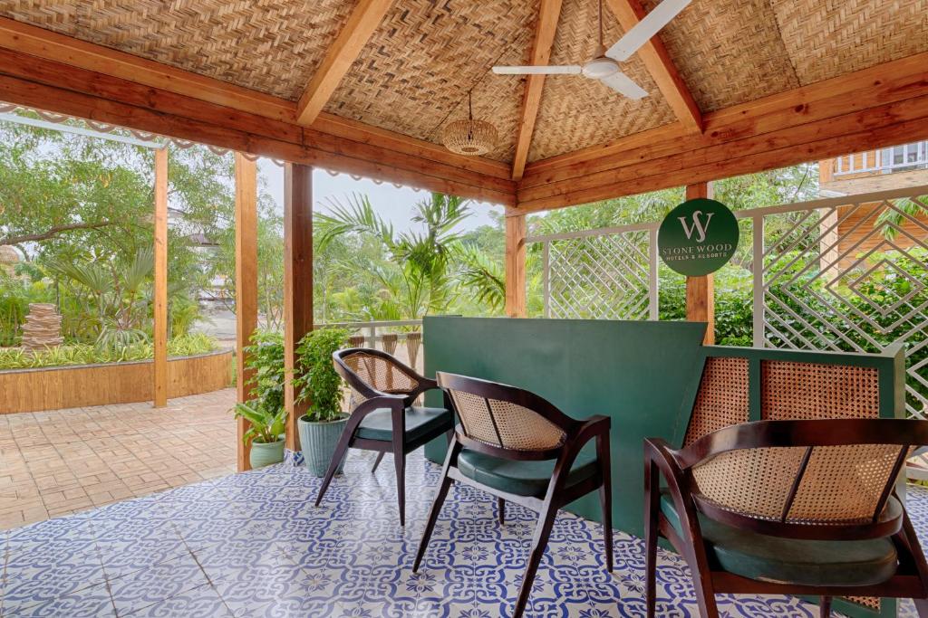a patio with chairs and a table with a ceiling at Aralea Beach Resort By Stone Wood Premier in Morjim