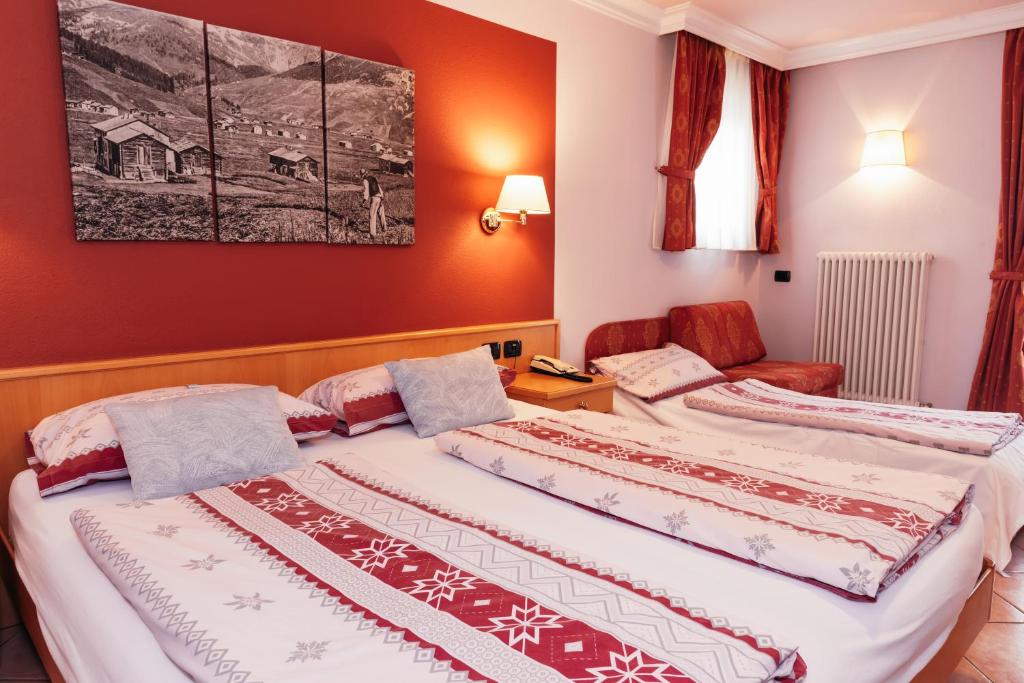 Postel nebo postele na pokoji v ubytování Hotel Garni Rin Da Rin