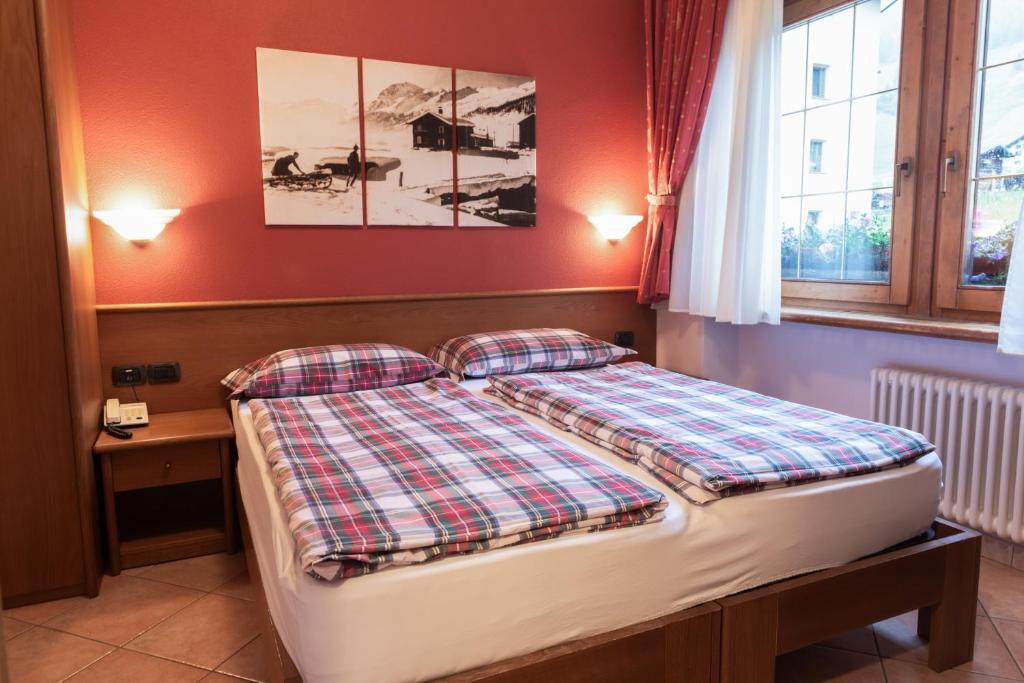 Postel nebo postele na pokoji v ubytování Hotel Garni Rin Da Rin