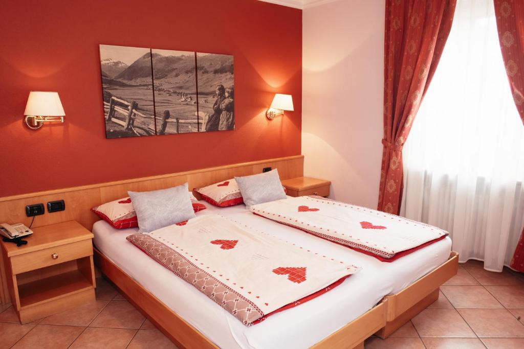 Postel nebo postele na pokoji v ubytování Hotel Garni Rin Da Rin