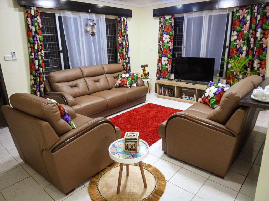 a living room with two couches and a television at Yaubula Accommodation 2 in Nadi