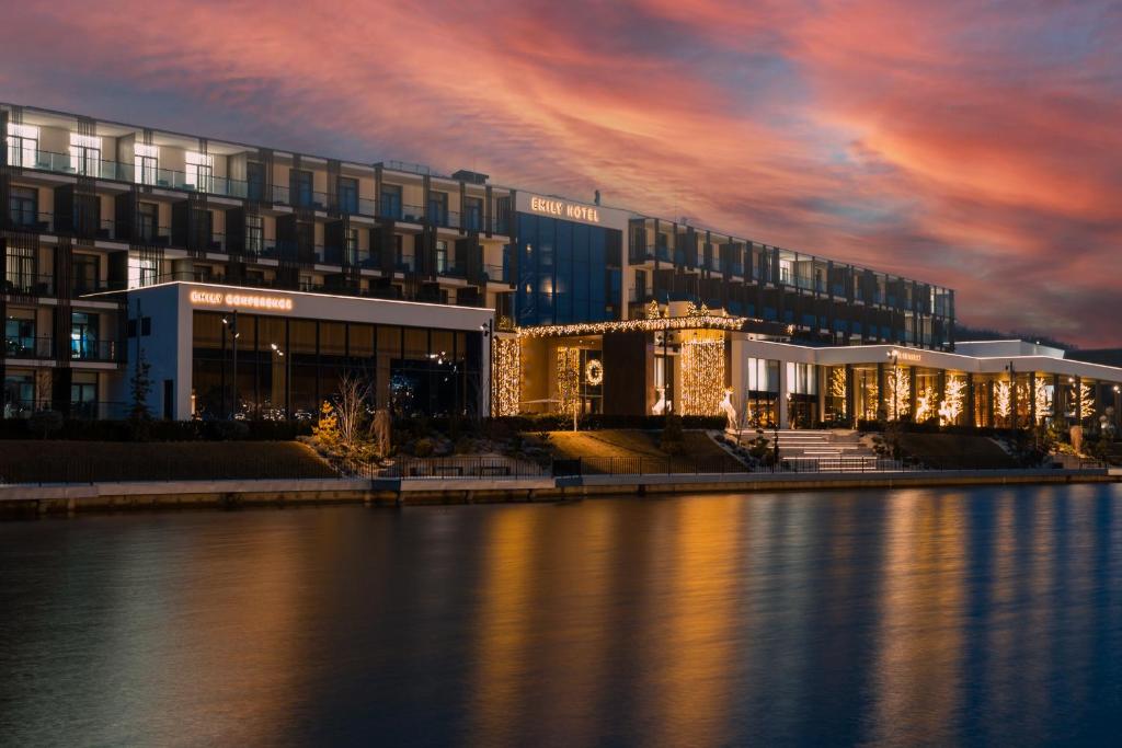 a large building next to a body of water at Emily Resort in Lviv