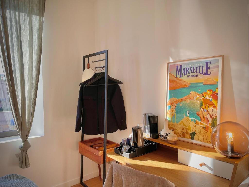 a room with a table with a mannequin on a shelf at Maï Homes - La Villa Bompard in Marseille