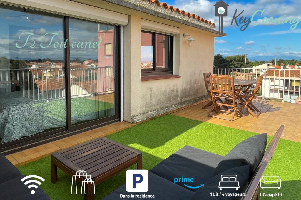 a patio with a couch and a table on a lawn at T2 Toit-Terrasse Canet - Plage à 5 min à pieds in Canet-en-Roussillon