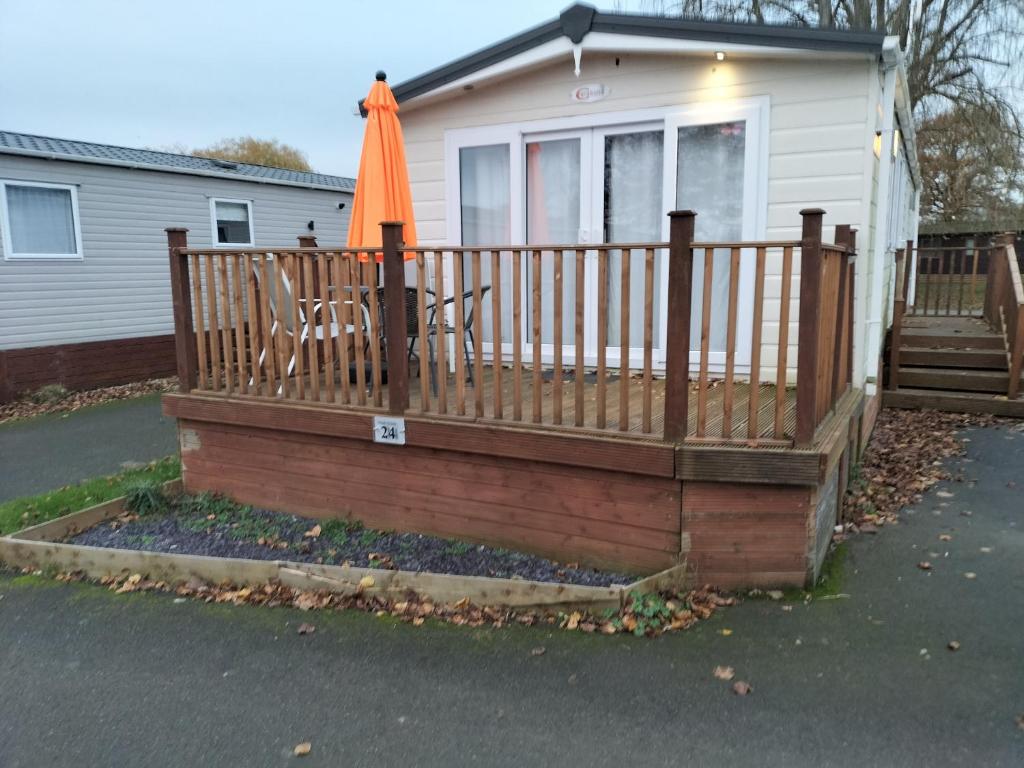 an orange umbrella on a fence in front of a house at 24 Shark Island in Great Billing