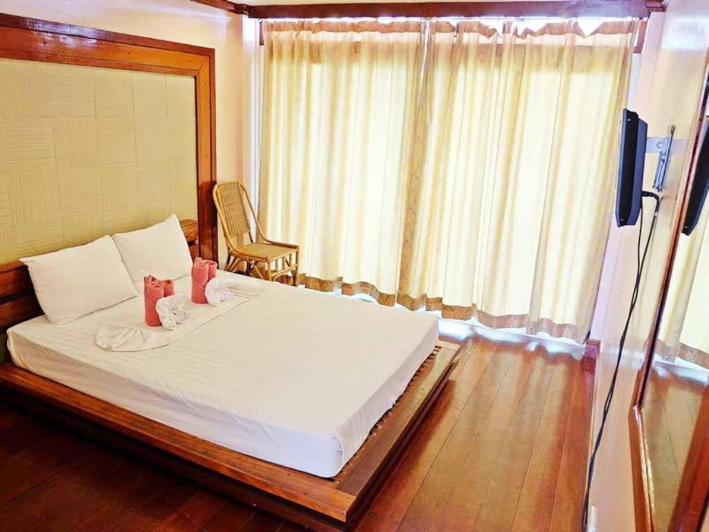 Postel nebo postele na pokoji v ubytování El Nido Beach Hotel