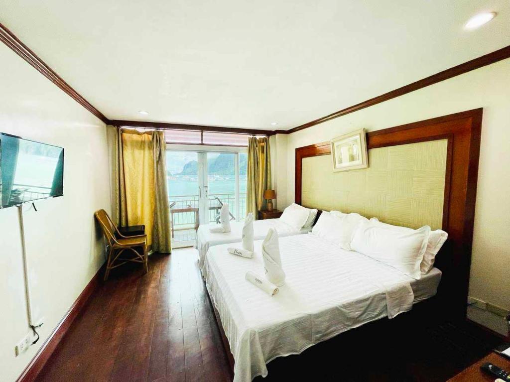 Postel nebo postele na pokoji v ubytování El Nido Beach Hotel