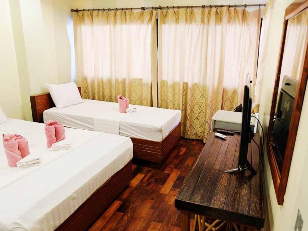 Postel nebo postele na pokoji v ubytování El Nido Beach Hotel