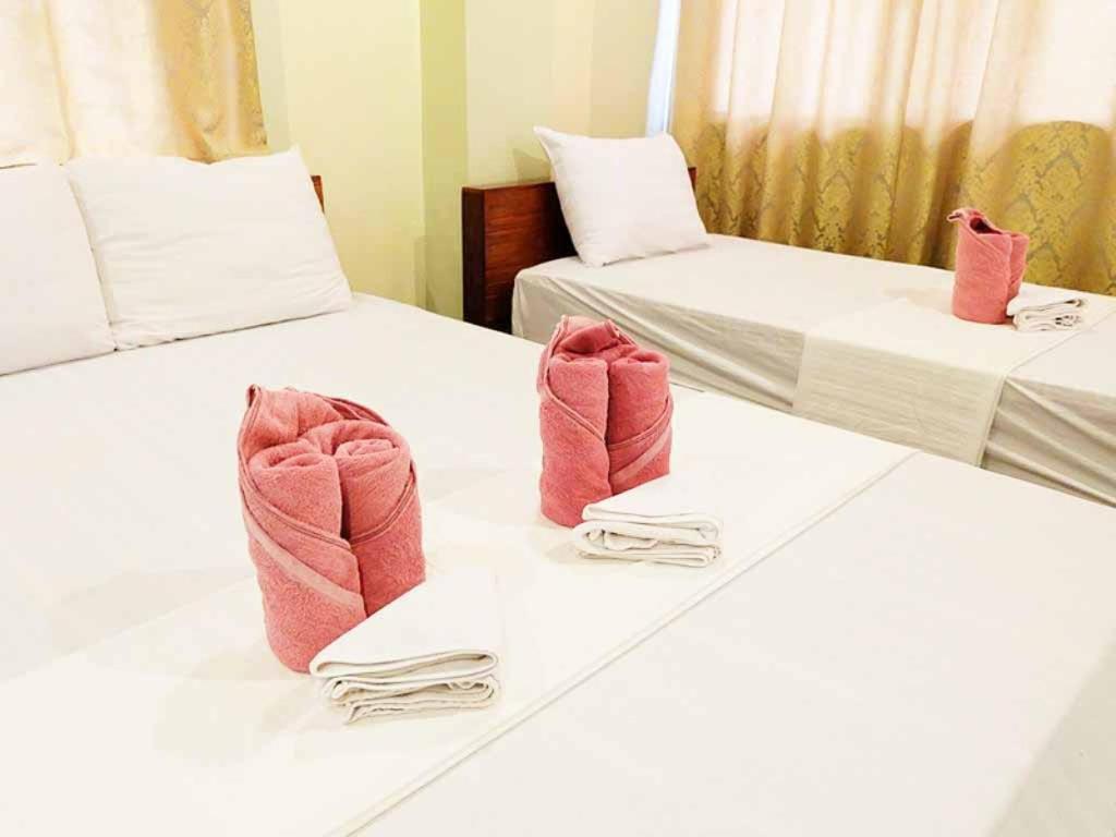 Postel nebo postele na pokoji v ubytování El Nido Beach Hotel