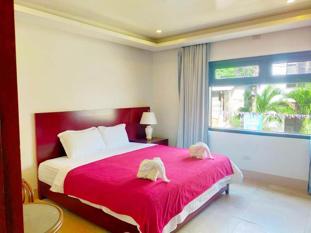 Postel nebo postele na pokoji v ubytování El Nido Beach Hotel