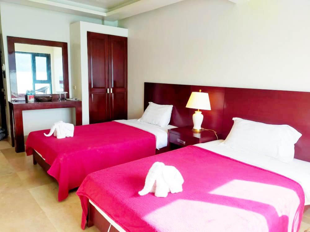 Postel nebo postele na pokoji v ubytování El Nido Beach Hotel