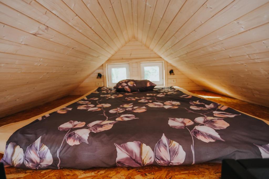 a bedroom with a large bed in a small room at Melamar in Smārde