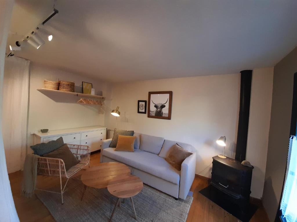 a living room with a couch and a table at Acogedor estudio con terraza Besiberri 4 in Pla de l'Ermita