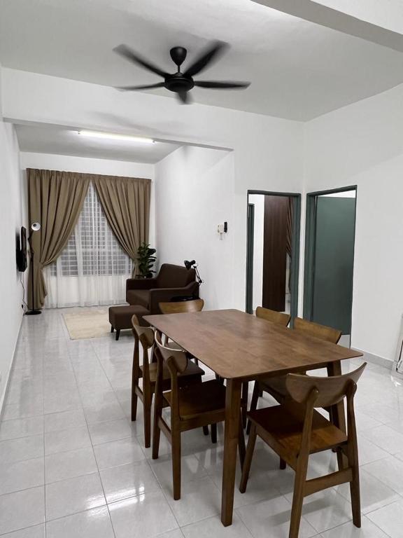 a living room with a wooden table and chairs at 162 RESIDENCY SELAYANG in Batu Caves