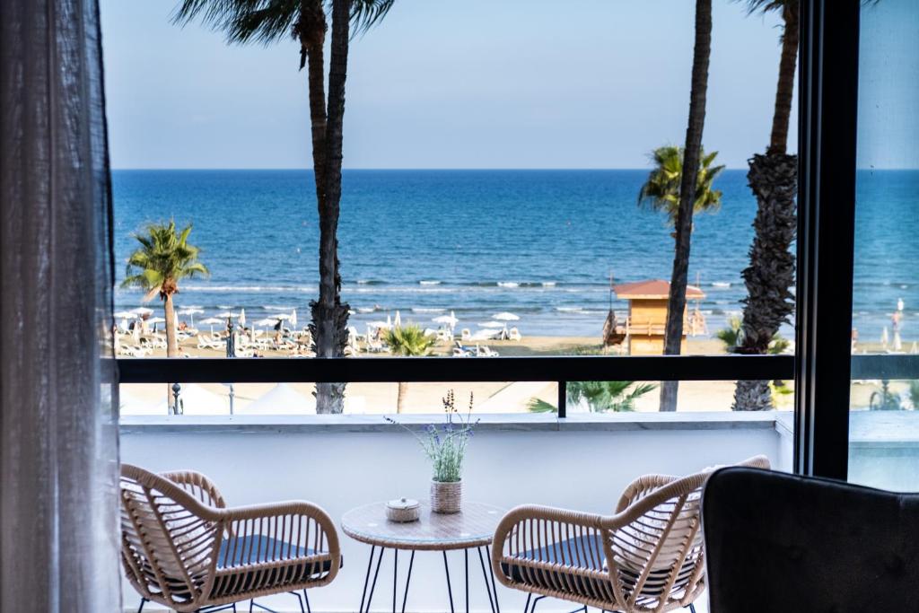 a view of the beach from a hotel room at Quattro Sea View Beachfront Ap.206 in Larnaca