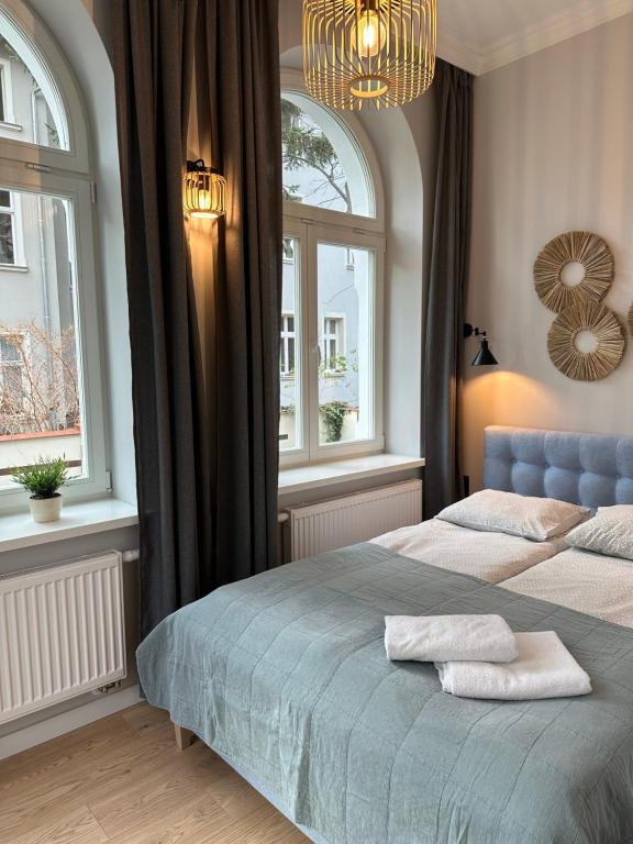 Postel nebo postele na pokoji v ubytování Kamienica Ogrodowa Rooms