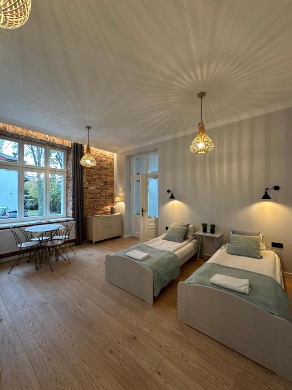 Postel nebo postele na pokoji v ubytování Kamienica Ogrodowa Rooms