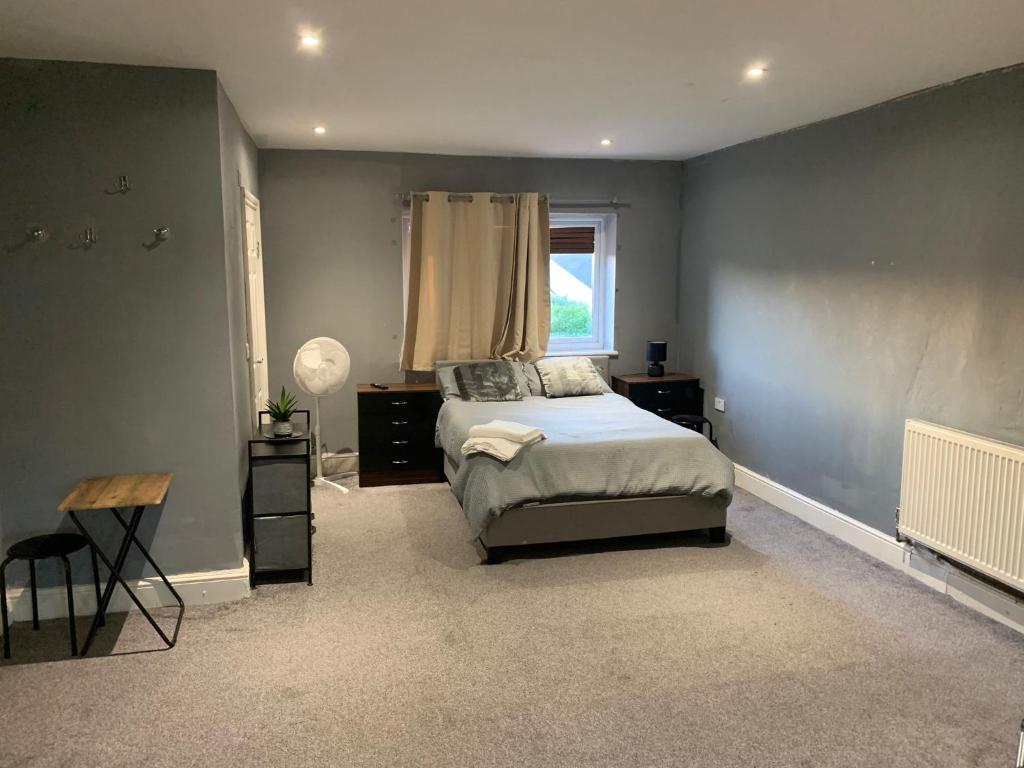 a bedroom with a bed and a window at R J Apartment in London