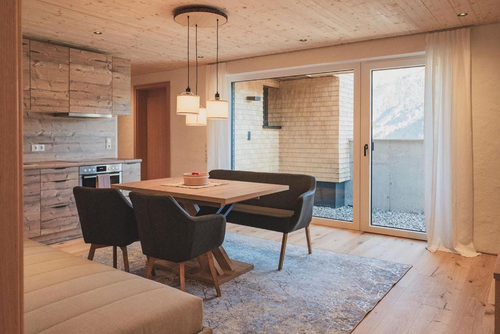 - une cuisine et une salle à manger avec une table et des chaises dans l'établissement Apartment Aurelian, à Vandans