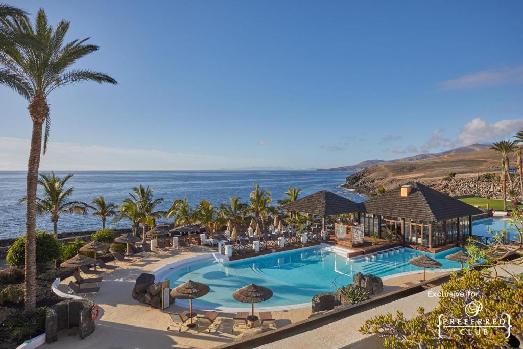 an aerial view of a resort with a swimming pool at Secrets Lanzarote Resort & Spa - Adults Only (+18) in Puerto Calero
