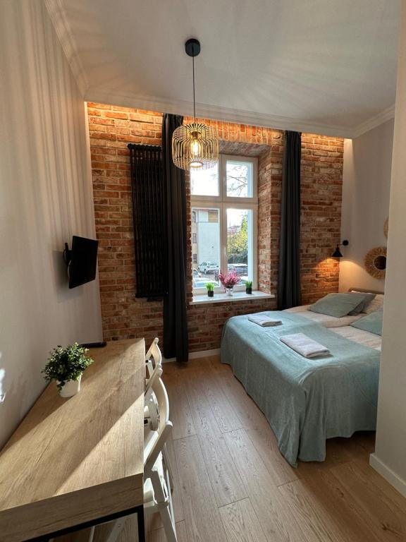 Postel nebo postele na pokoji v ubytování Kamienica Ogrodowa Rooms