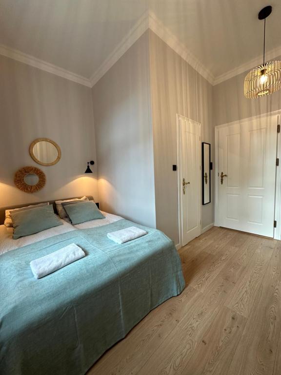 Postel nebo postele na pokoji v ubytování Kamienica Ogrodowa Rooms