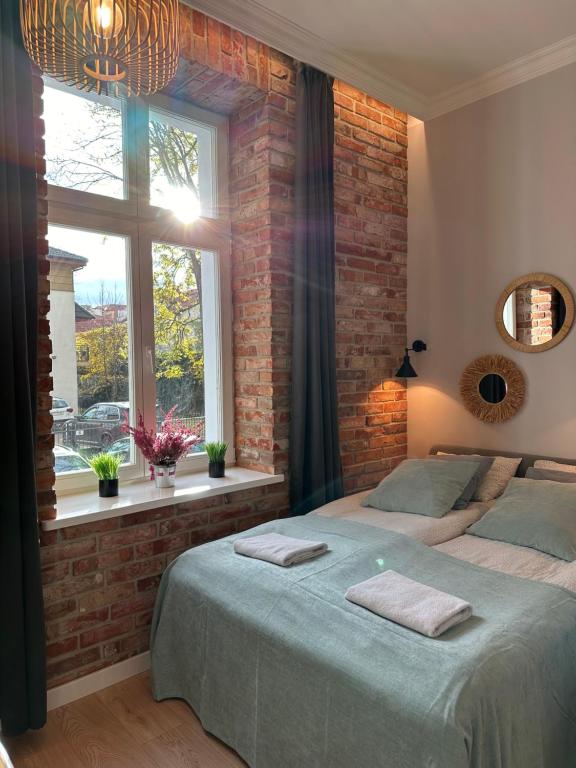 Postel nebo postele na pokoji v ubytování Kamienica Ogrodowa Rooms