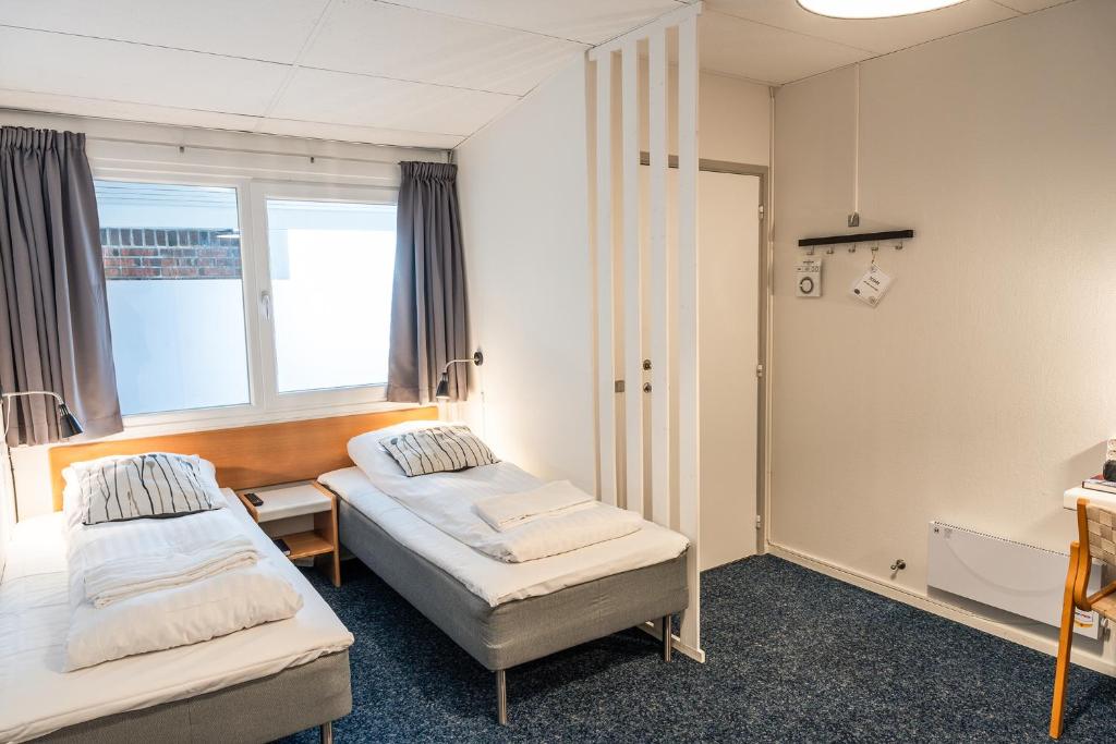 Postel nebo postele na pokoji v ubytování Hotel Herning