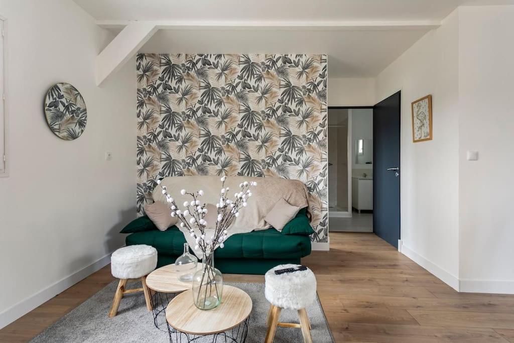 sala de estar con sofá verde y mesa en Les Chalets du Mancel - Chalet Vakiry - 500 m Bouleries Jump , 10 min du circuit des 24h, en Parence