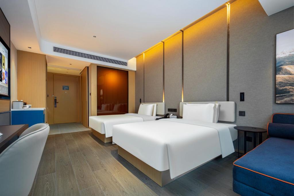 Postel nebo postele na pokoji v ubytování Atour Hotel Meizhou West Station R&F Center