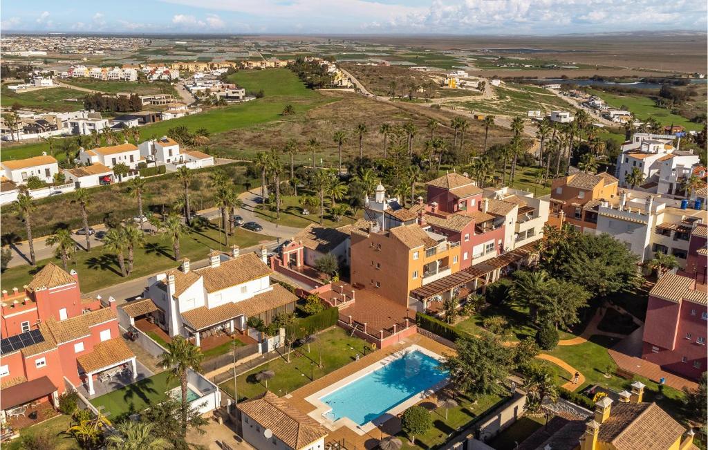an aerial view of a city with houses and a pool at Gorgeous Apartment In Sanlcar De Barrameda With Wifi in Sanlúcar de Barrameda