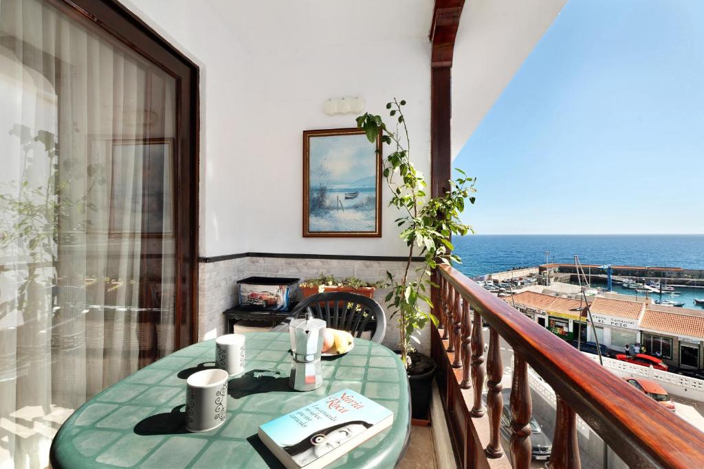 een tafel op een balkon met uitzicht op de oceaan bij Apartamento el descanso in Candelaria
