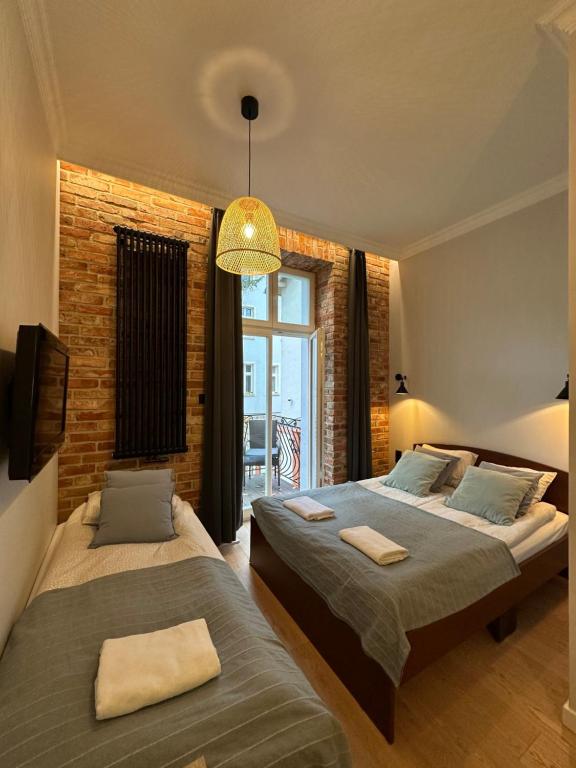 Postel nebo postele na pokoji v ubytování Kamienica Ogrodowa Rooms