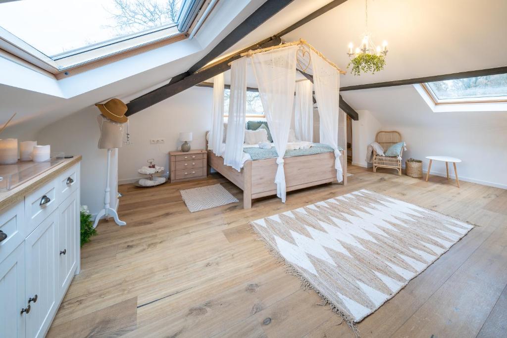 a bedroom with a canopy bed in a attic at La gazza ladra in Namur