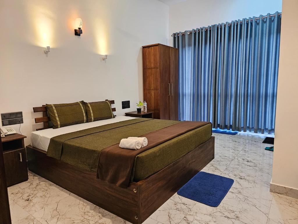a bedroom with a large bed and a large window at Golden sky in Kandy