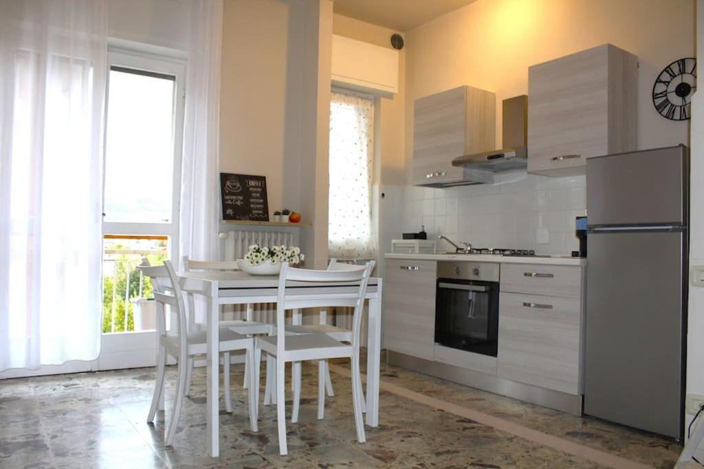 eine Küche mit einem Tisch und Stühlen sowie einem Kühlschrank in der Unterkunft Venere Apartment in Bergamo