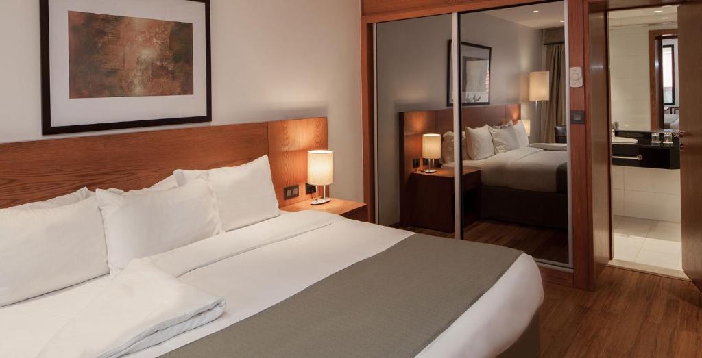 Postel nebo postele na pokoji v ubytování Eko Hotel Gardens